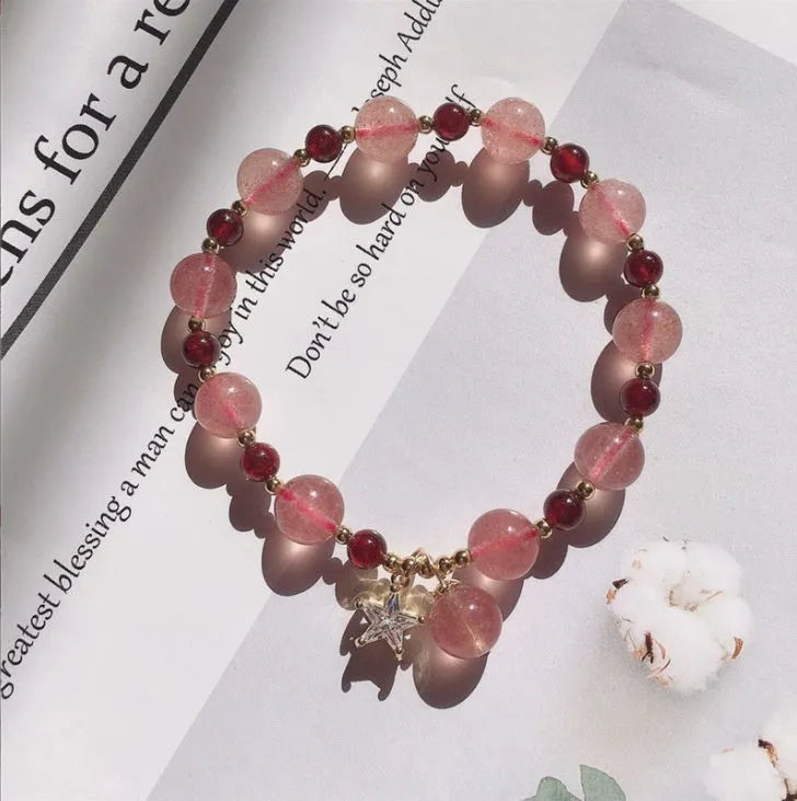 Handmade natural strawberry quartz crystal bracelet for women with moon and pearl bead designs.