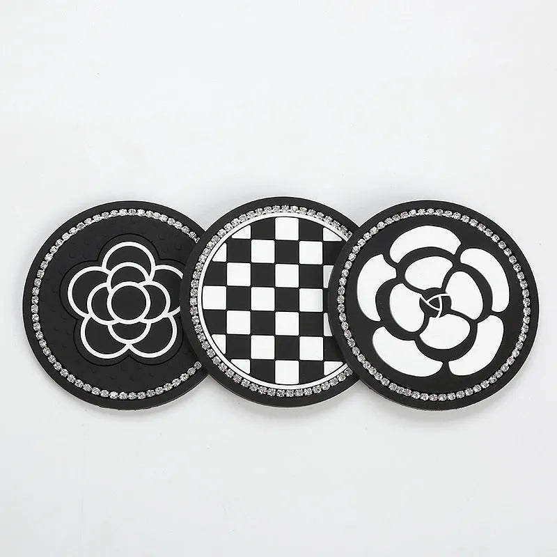 Black and white checkerboard PVC car cup holder mat inserted into vehicle centre console slot