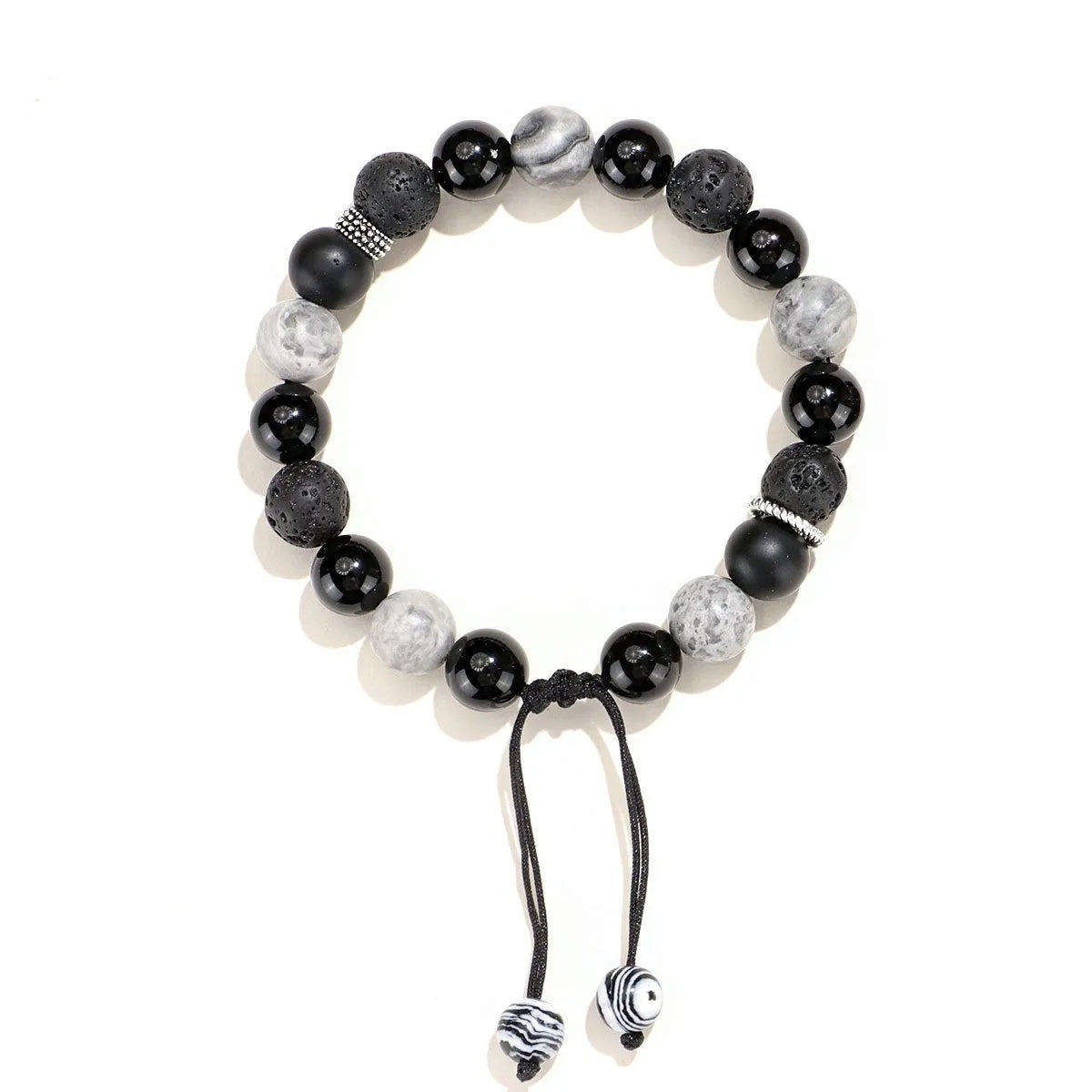 Black agate map stone and volcanic rock bracelet in diamond shape on a wrist.