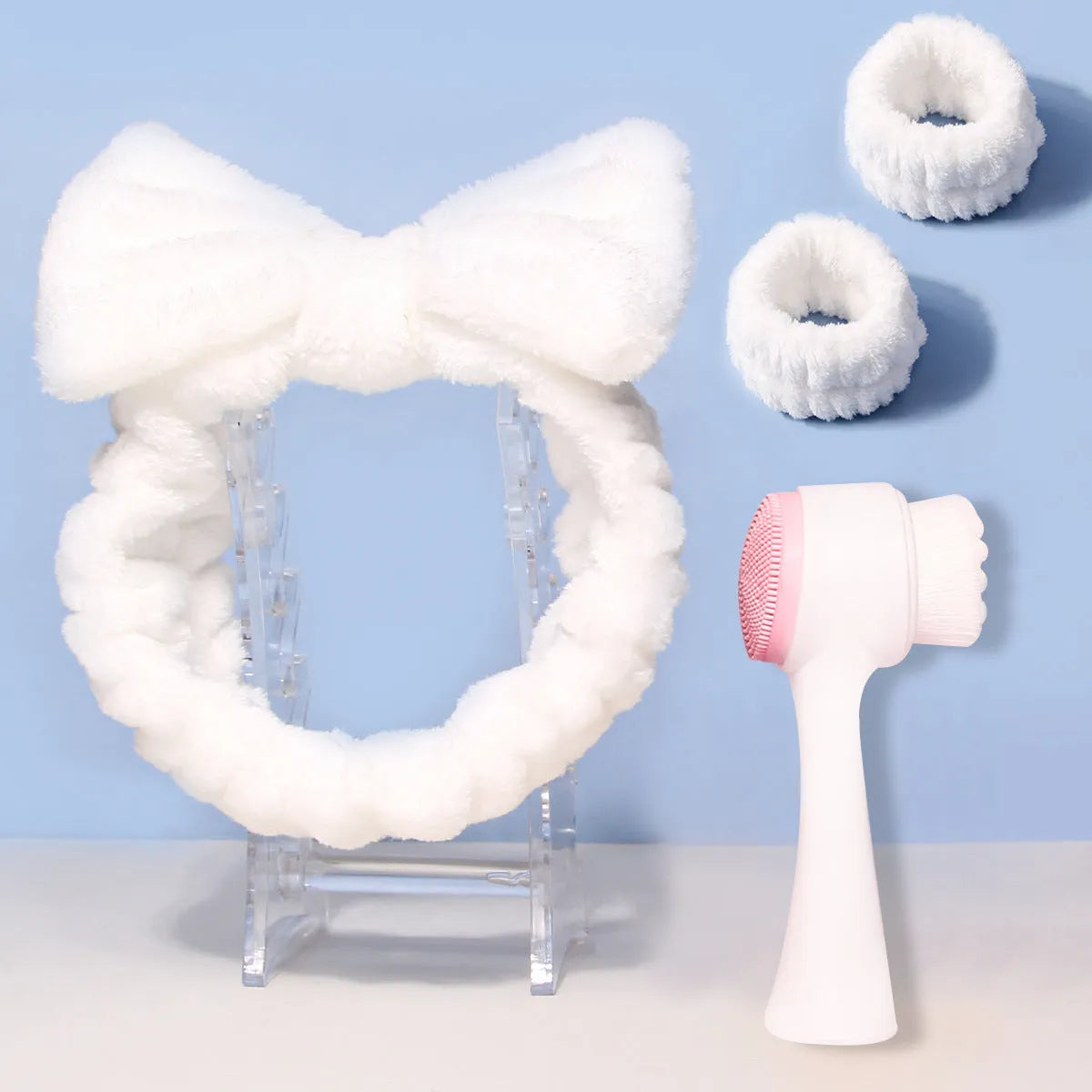 Facial brush set with coral fleece hair band, nylon bristle brush, and plastic toothbrush in purple, grey, white, or pink colours