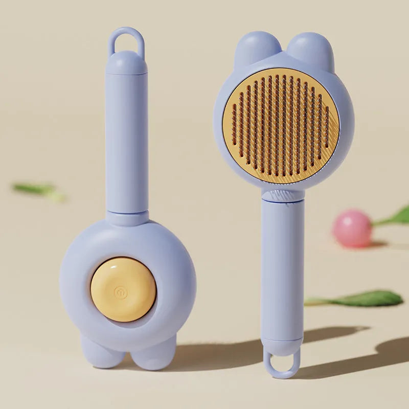 Self-cleaning pet grooming brush with green handle and stainless steel comb, showing the one-click release button.
