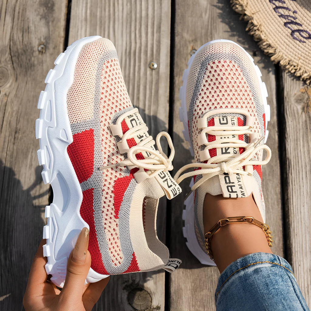 Women's Flyknit mesh lace-up sneaker in a grey colourway, showing the breathable upper and rubber sole.