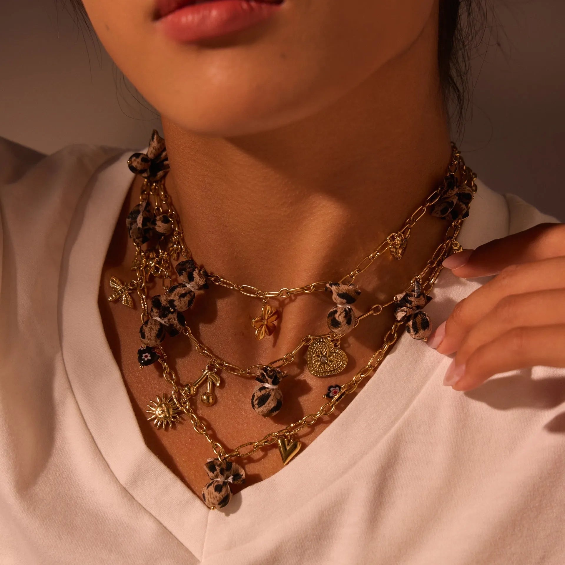 Gold-plated leopard pendant necklace with love heart and flower detailing on adjustable chain