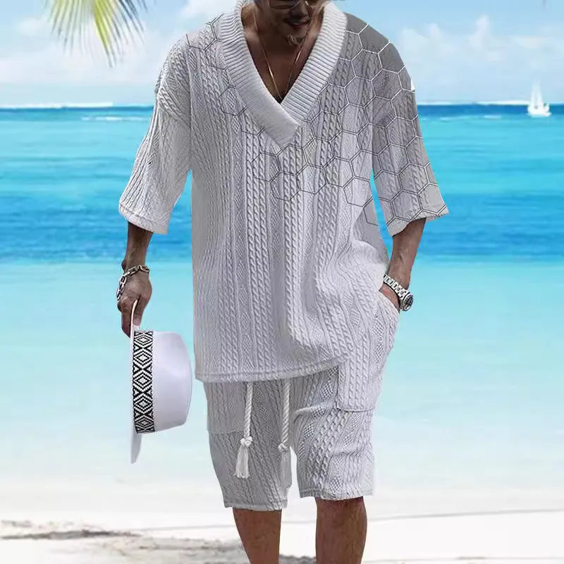 A man wearing a printed drop-shoulder knitted short-sleeved top with matching shorts in a casual setting.