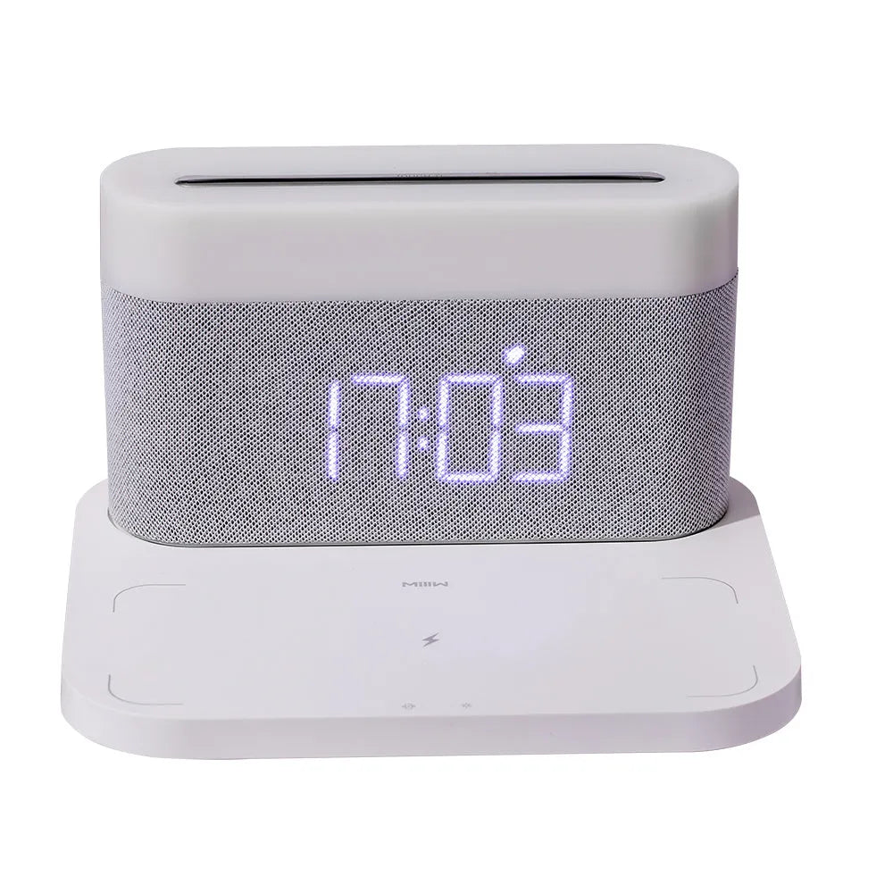 Black wireless charging desk clock with LED display and night light on wooden surface