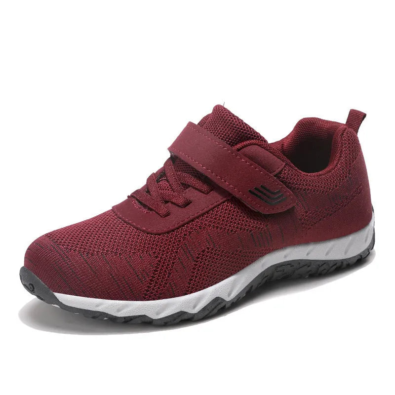 Women's low-top wedge heel shoes with mesh upper and Velcro strap in a solid colour.
