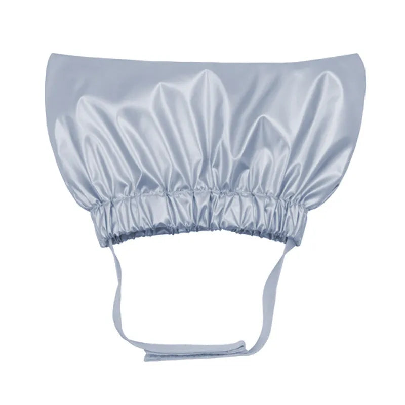 A silver waterproof shower cap for dogs and cats, shown adjusted to fit over pet ears.