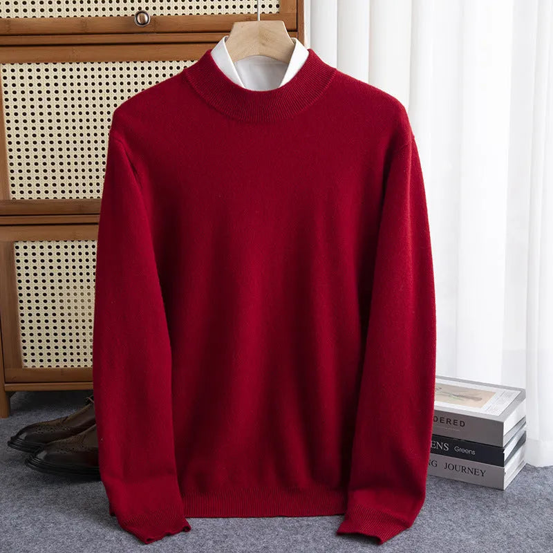 Man wearing a loose-fit, chunky knit wool sweater with a half-turtleneck collar in a neutral colour.
