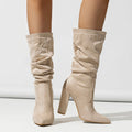 Women's black suede ankle boots with a high chunky heel and pointed toe.