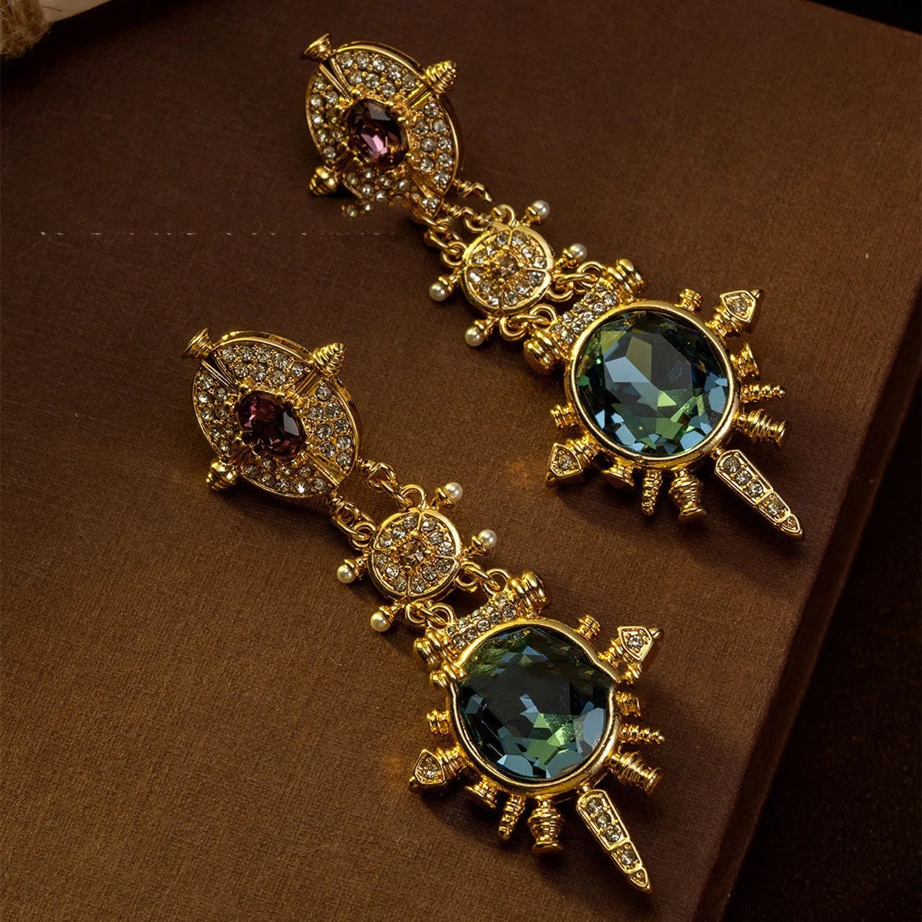 A pair of gold colour geometric round stud earrings with a retro court style design.
