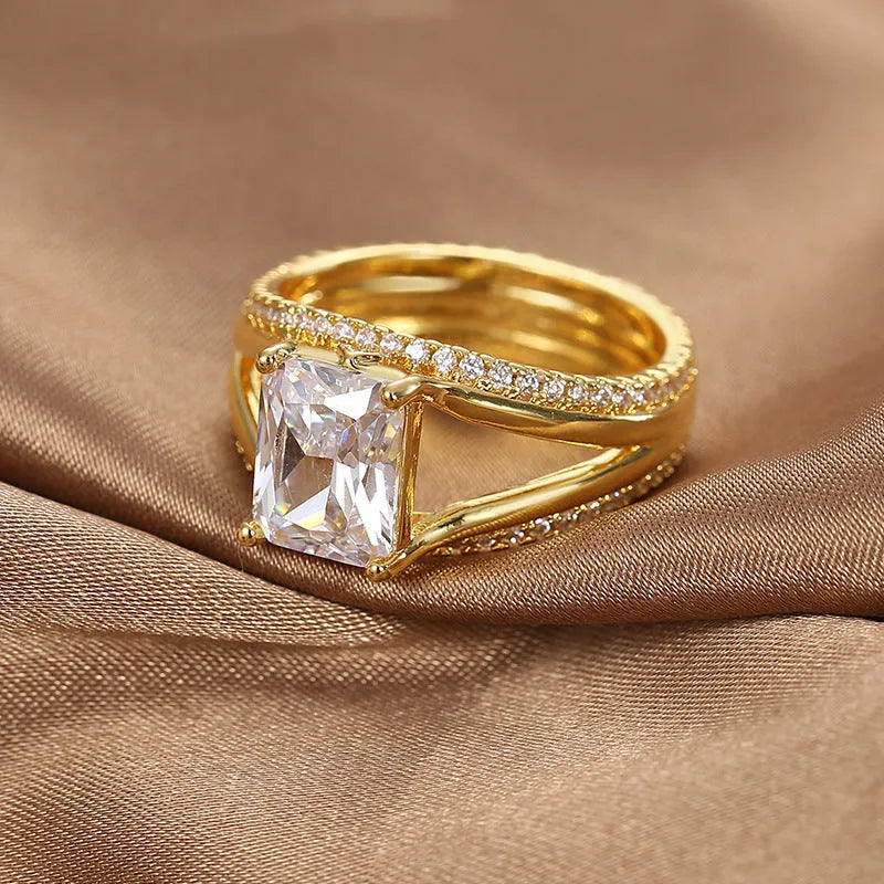 Geometric women's ring with gold electroplated finish and square zircon centrepiece on copper base