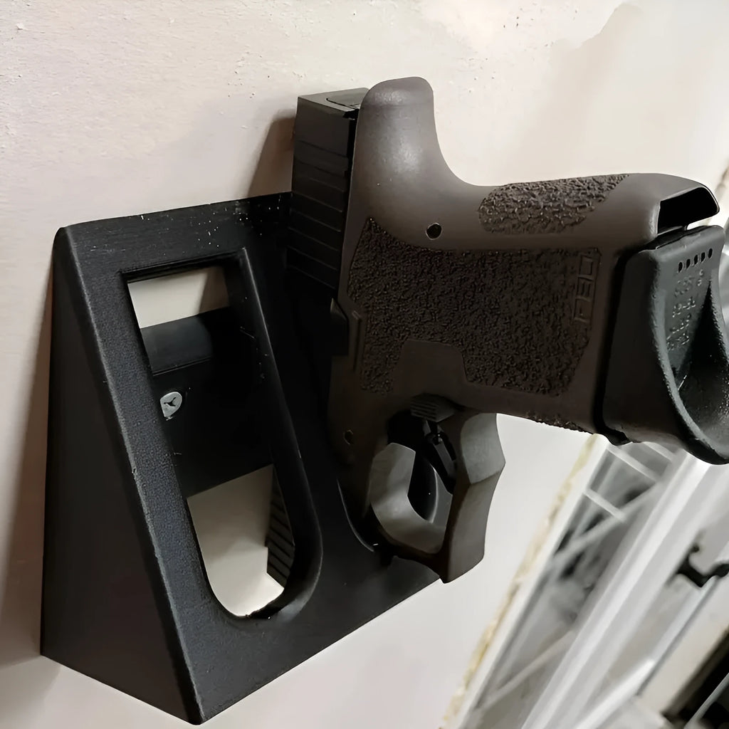 Black plastic pistol display stand with punk-style moulding for 1:1 scale gun models.