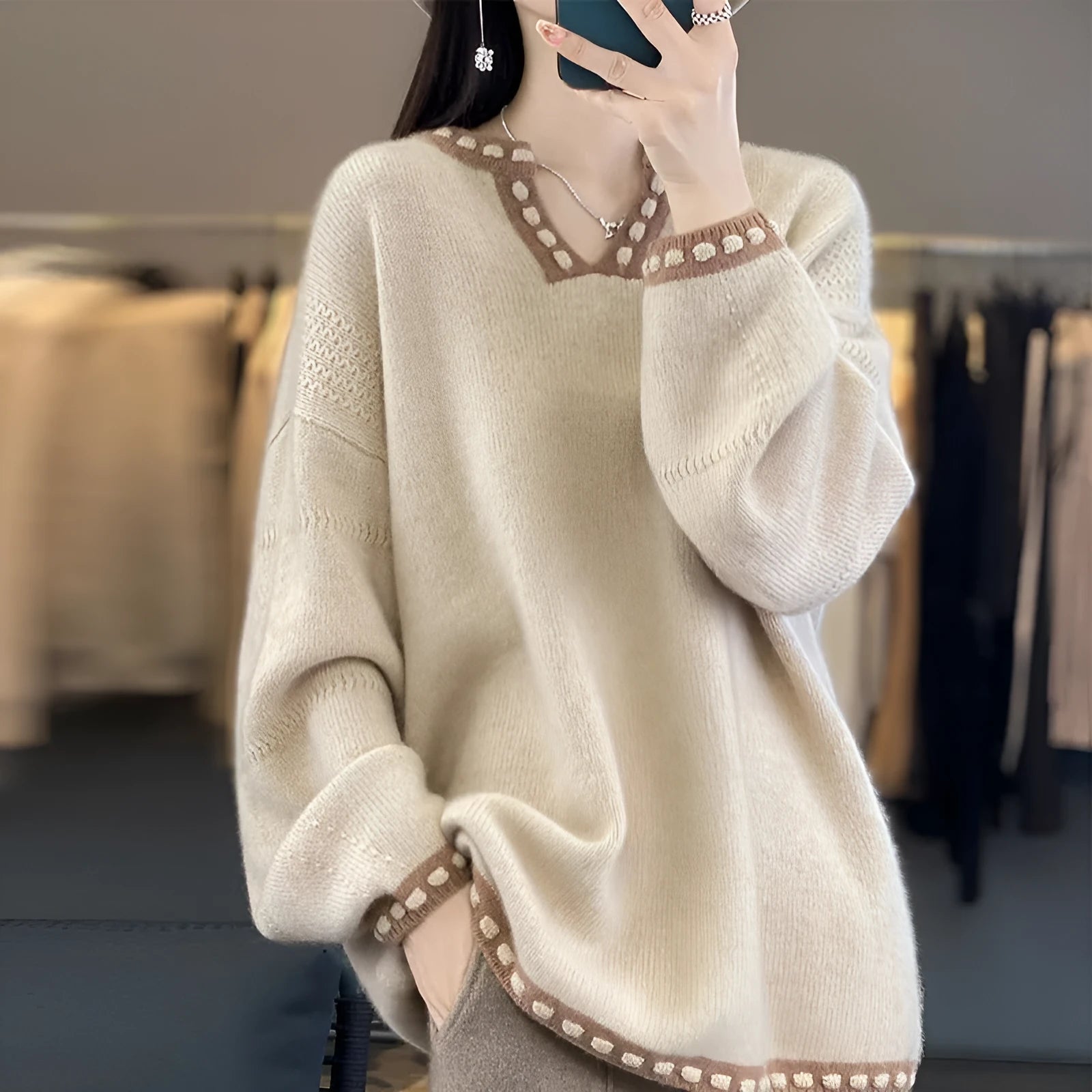 Women's camel coloured V-neck viscose sweater with long sleeves laid flat.