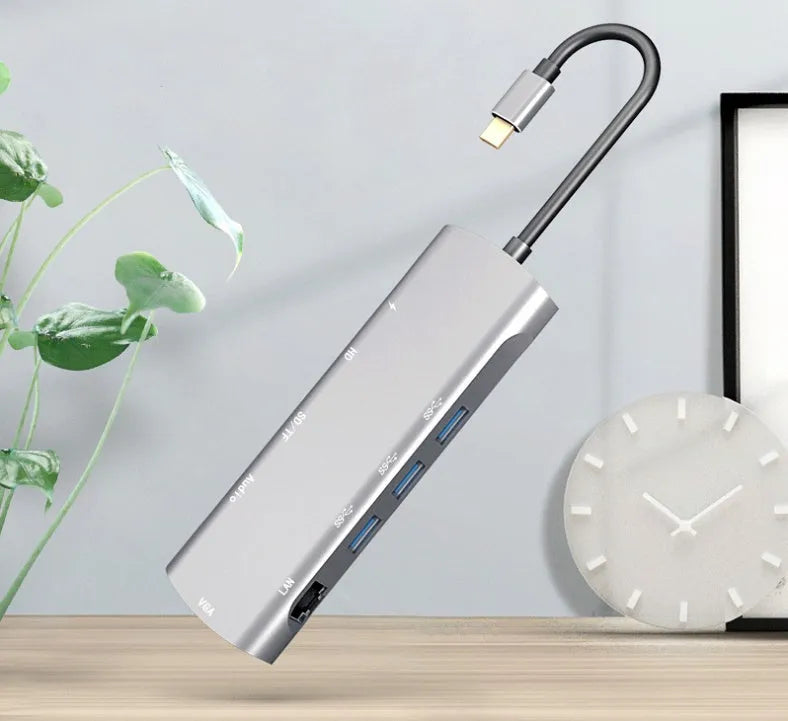 Grey aluminium USB-C docking station with HDMI, VGA, USB ports and a short connecting cable