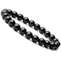 Close-up of a women's geometric bracelet with black agate beads on a black elastic cord.