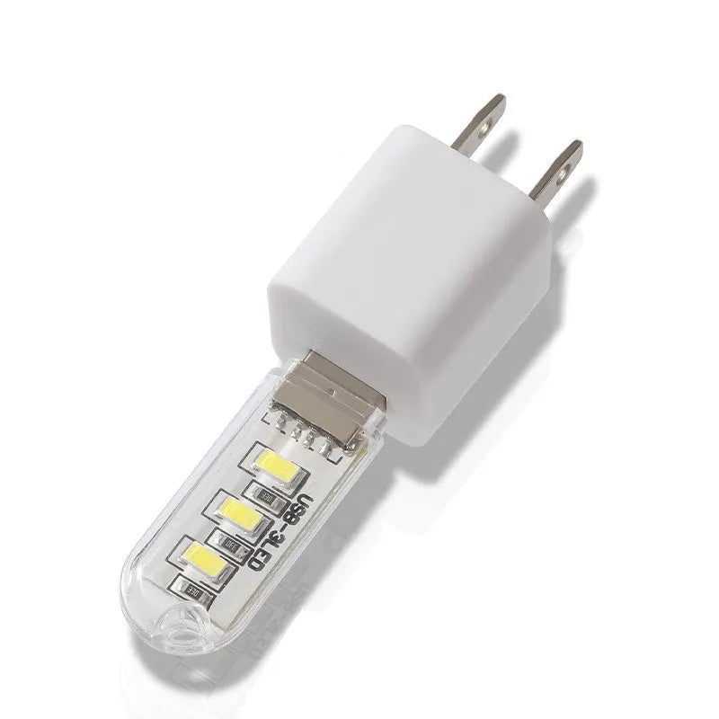 Small white LED baby night light with USB cable showing white and warm light settings