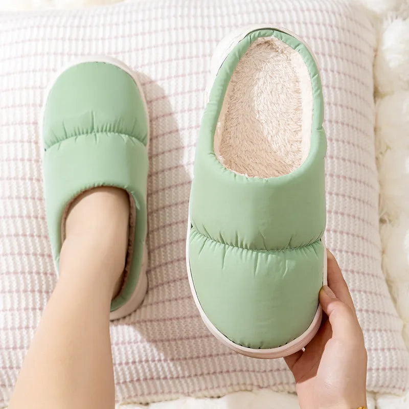 Pair of thick-soled winter slippers with artificial leather upper and plush lining, shown in a choice of colours.