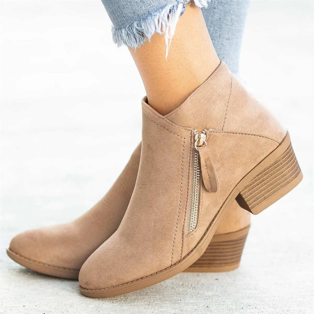 Women's blue suede ankle boot with chunky heel and side zip, on a white background.