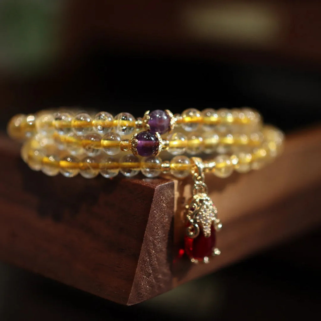 Natural rutilated quartz bracelet with gold rutile inclusions and Chinese style gold accent beads
