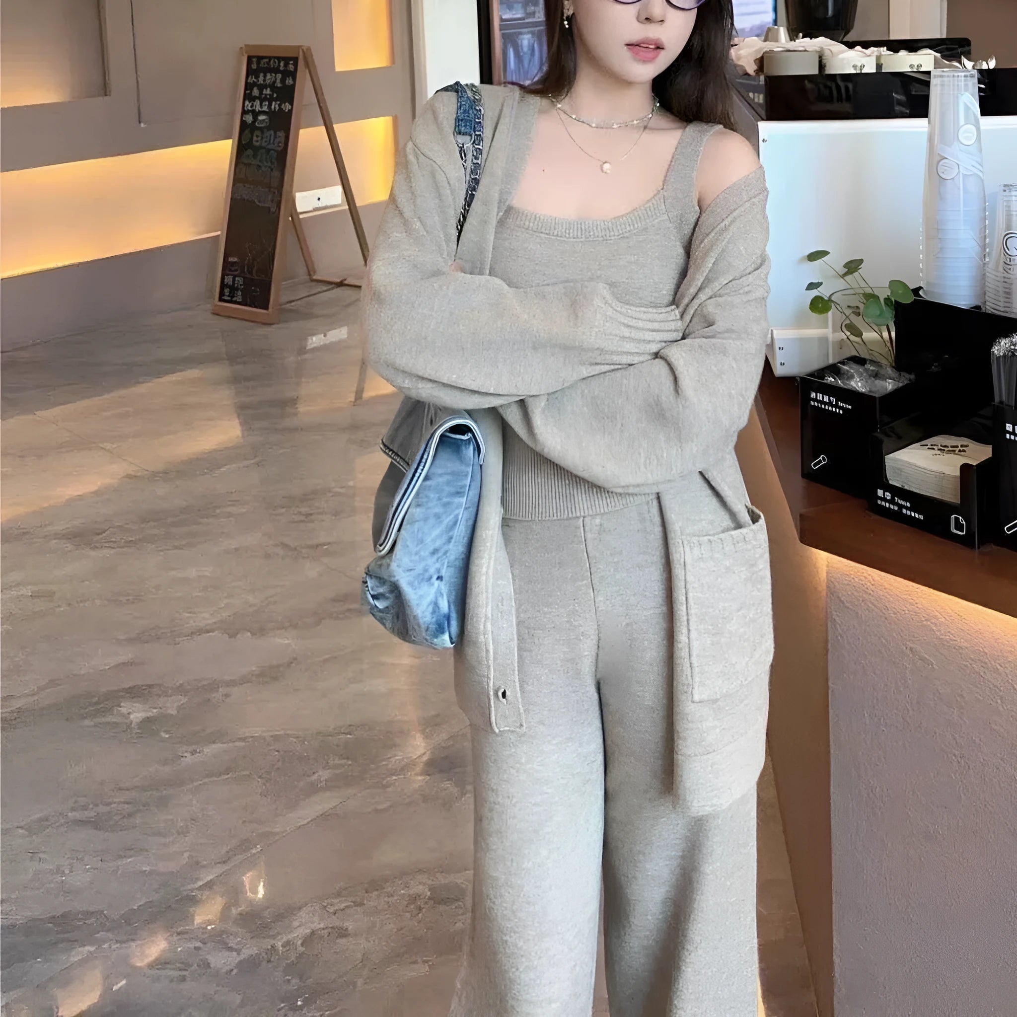 Women's knit three-piece set showing cardigan coat, vest, and suspender trousers in beige colour