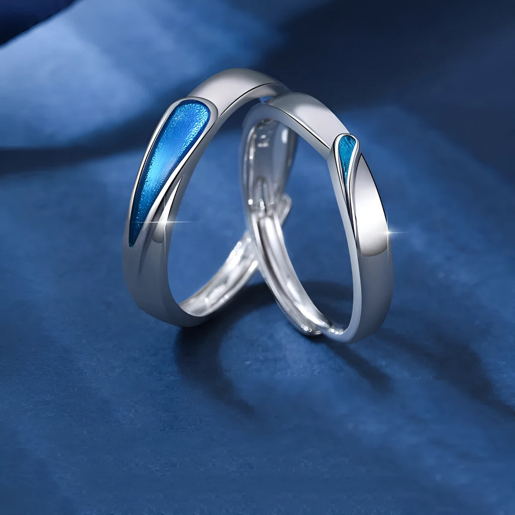 Blue tear drop copper ring with water drop shape and glue-drip finish on a dark background