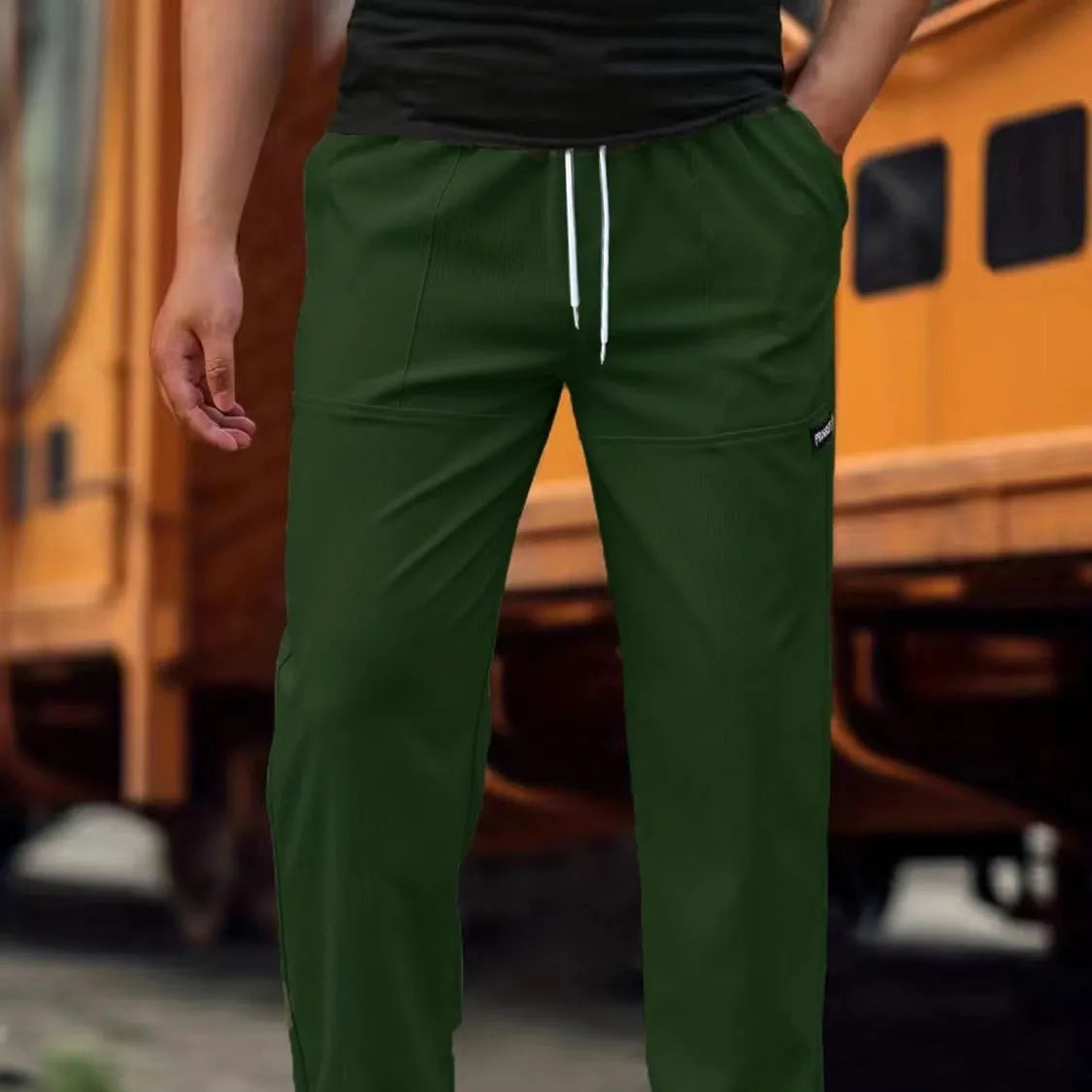 Men's polyester trousers for spring and autumn in light grey, shown flat.
