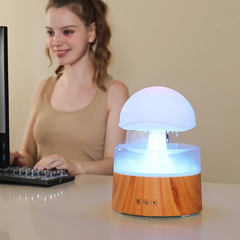 White rain cloud shaped ultrasonic humidifier and aroma diffuser with LED lighting showing rainfall simulation effect