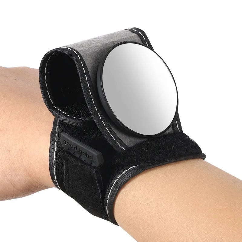 Black nylon wrist-mounted rear-view mirror for bicycles on a cyclist's wrist.