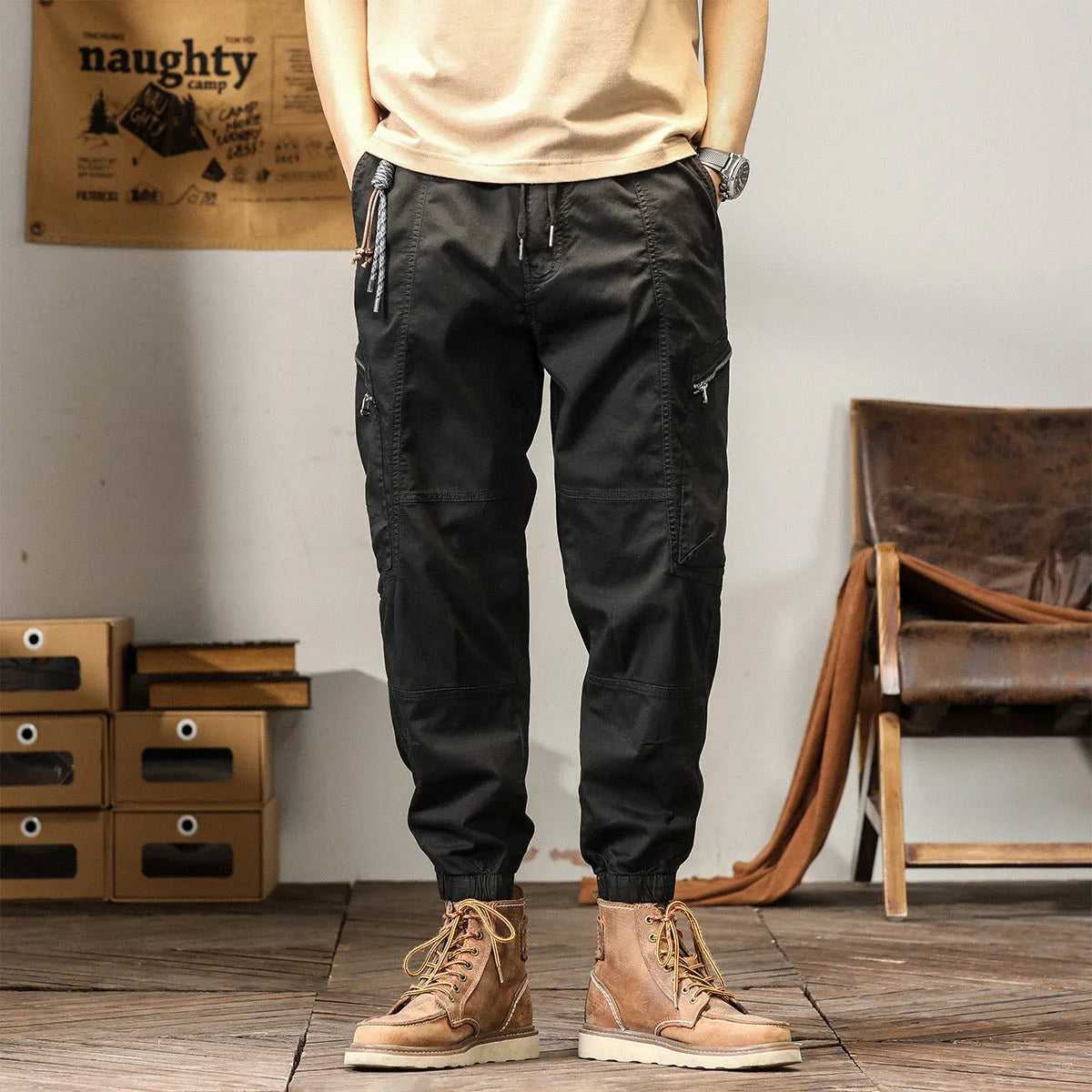 Men's khaki cotton harem pants with tapered ankle bands and a mid-waist zip fly.