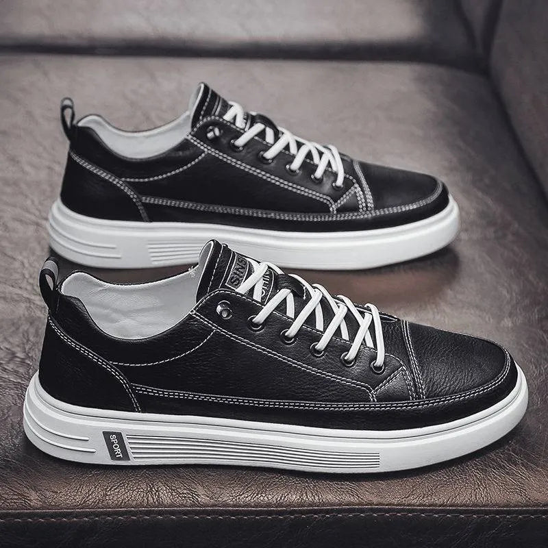 Men's casual white shoes with round toe and flat low-heel sole on a plain background.