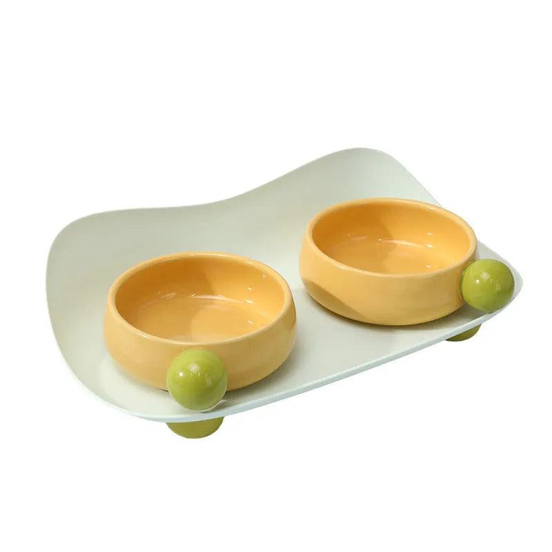 Double raised ceramic pet feeding bowl set with non-slip base in pink colour