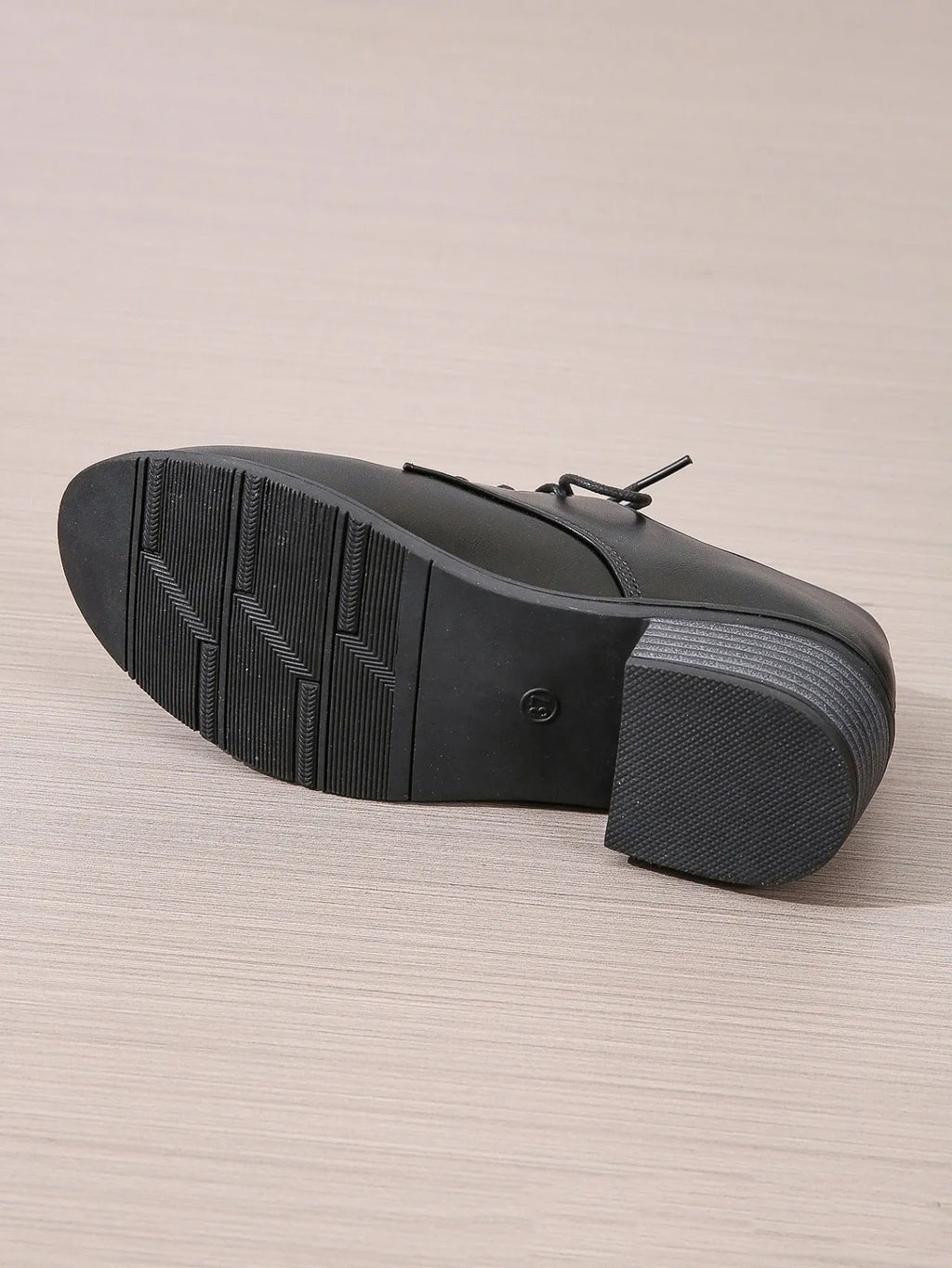 Black women's low-top shoes with a chunky thick heel and rubber sole.