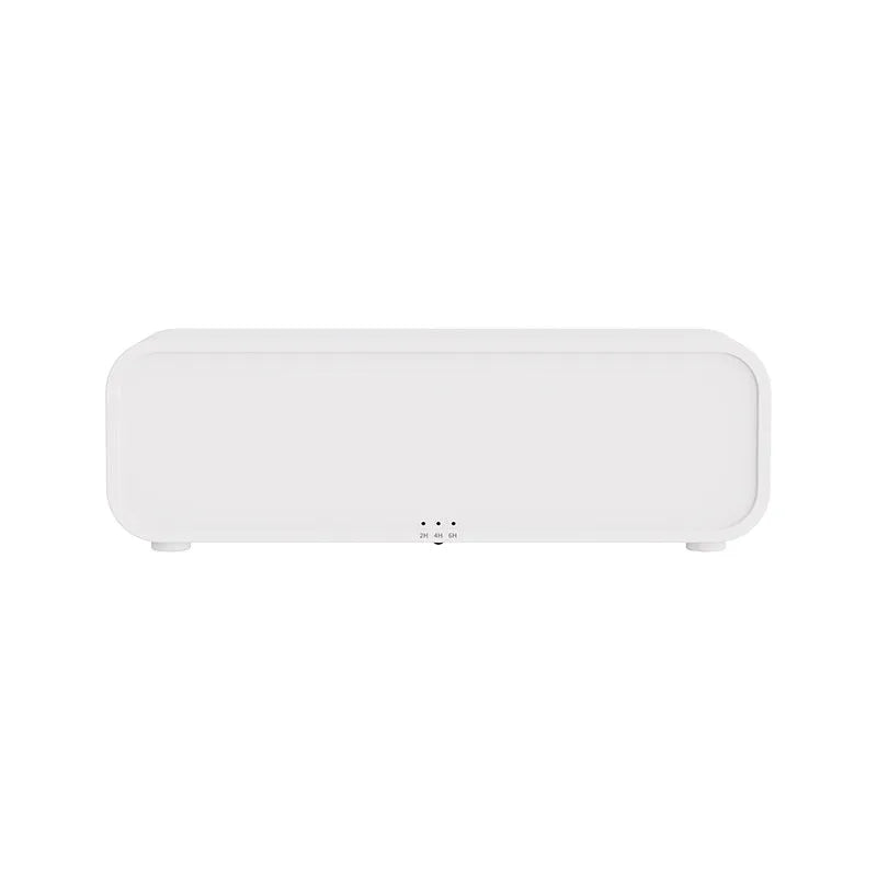 Black and white USB aroma diffuser with remote control on a desk, showing colour-changing LED lights.