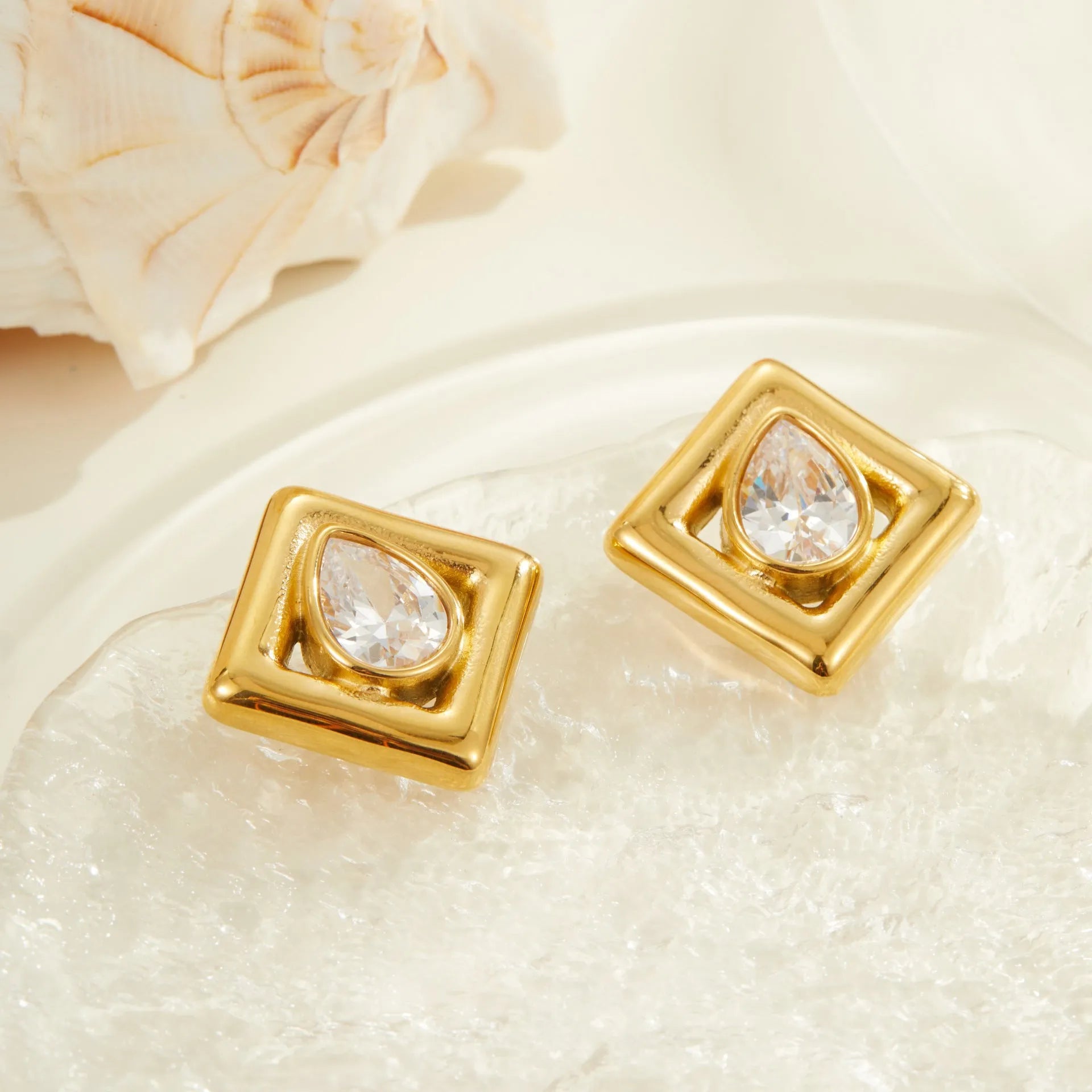 Geometric water drop shaped stud earrings with zircon inlay and gold electroplated finish