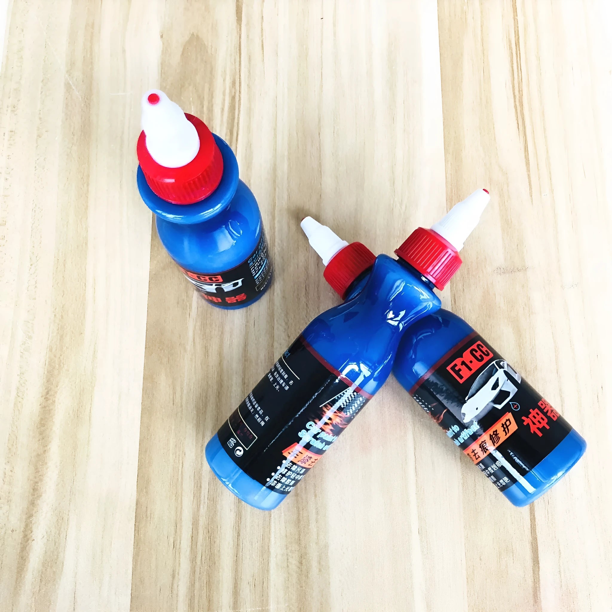 Blue automotive scratch repair agent with applicator sponge for car paint damage restoration