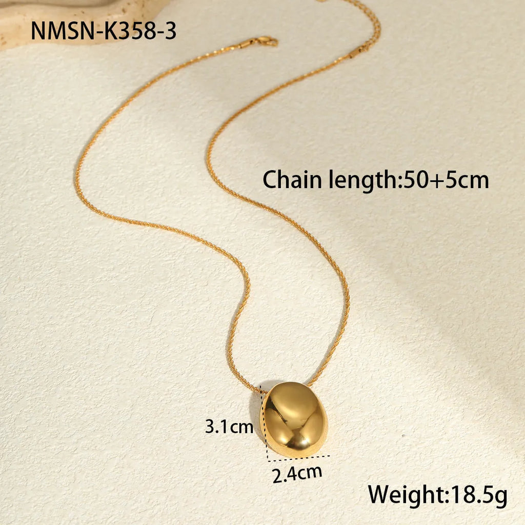 Gold-plated geometric pendant necklace with stainless steel chain on black background