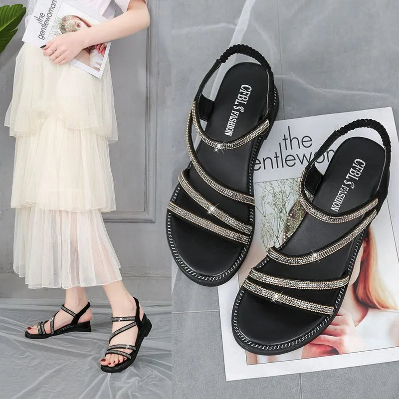 Women's flat casual sandals in gold with rhinestone fairy detail and elastic band.