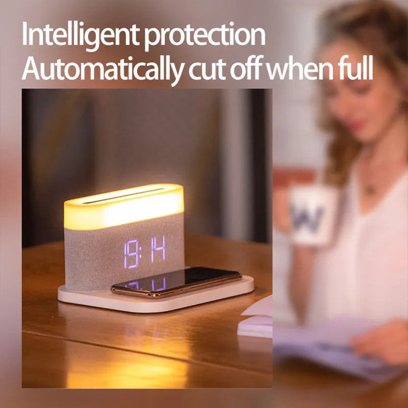 Black wireless charging desk clock with LED display and night light on wooden surface