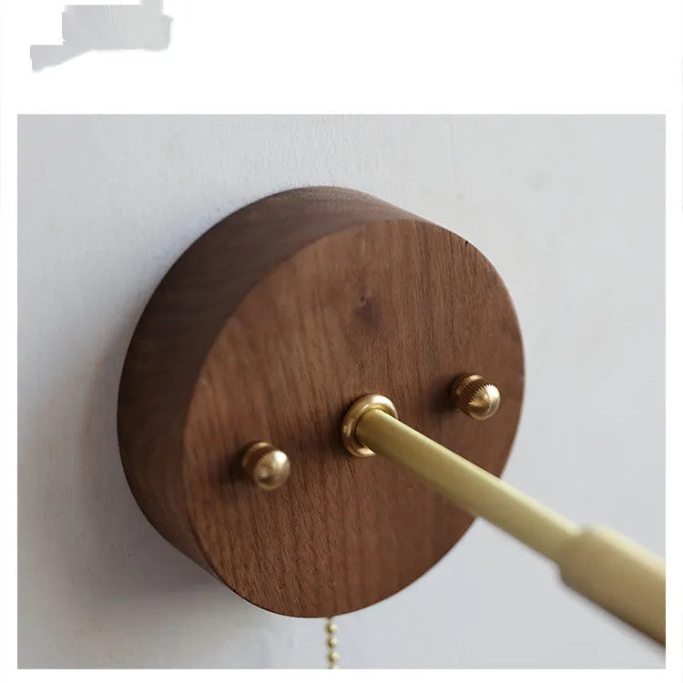 Nordic style wooden wall lamp with walnut finish mounted beside a bed