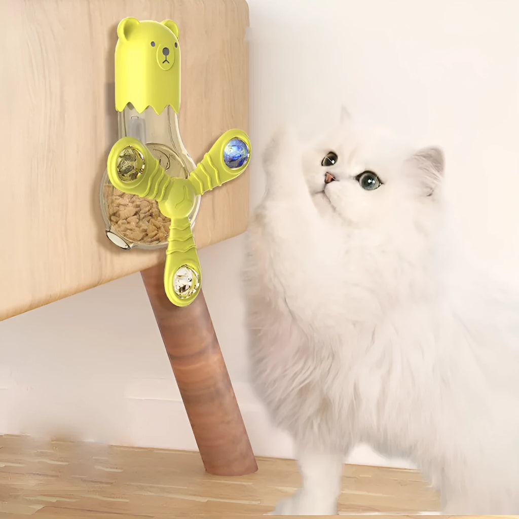 Interactive cat toy with light sound rotation and leak function in blue pink yellow off-white on floor