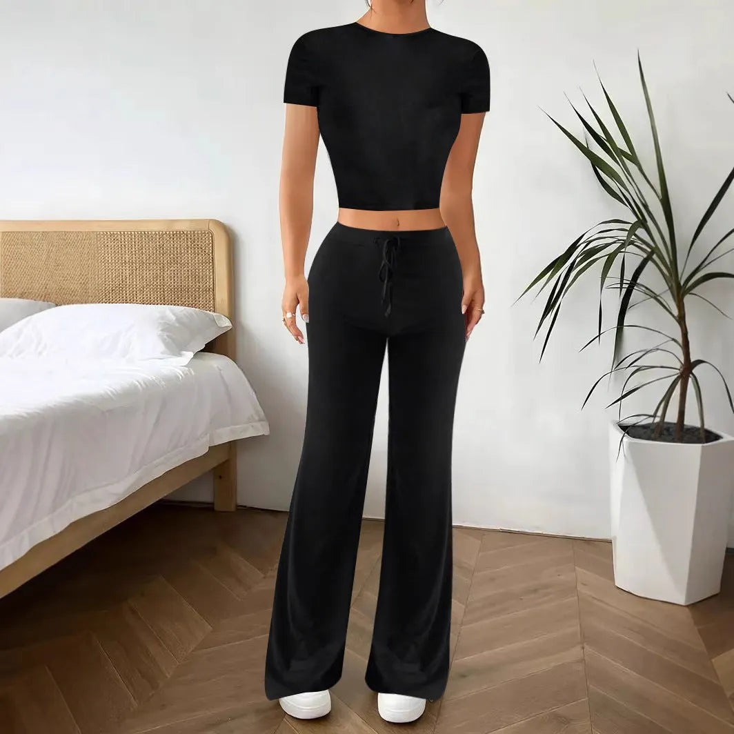 Black high waist trousers and short sleeve t-shirt women's co-ord set on a hanger.