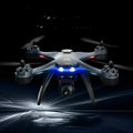 GPS quadrocopter drone with anti-fall protection and dual cameras, shown with remote controller and spare blades