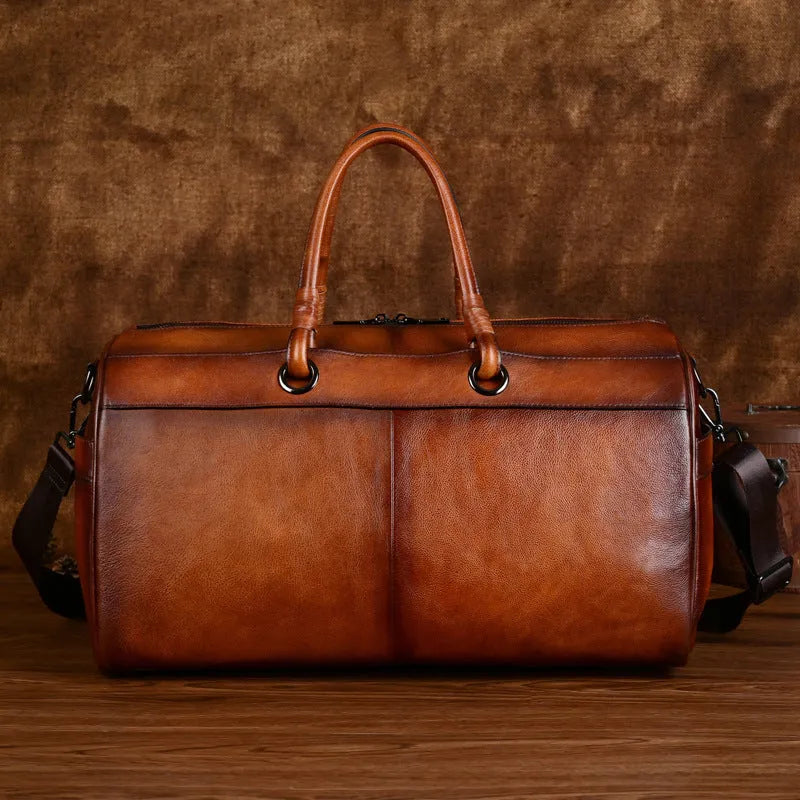 Handmade retro style leather travel bag in vintage brown colour showing expansion functionality