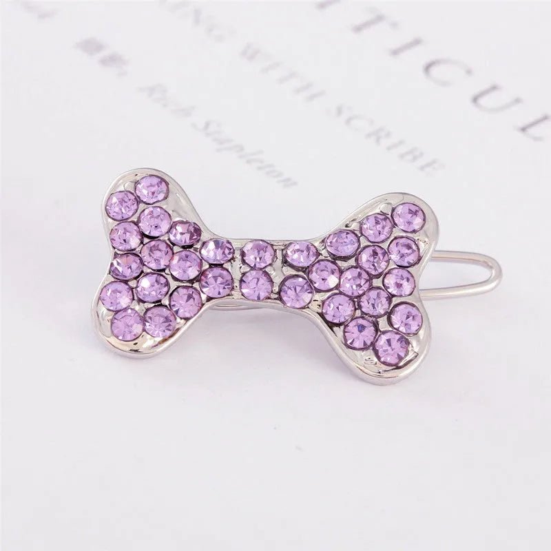 Rhinestone dog bone hair clip in alloy, white colour, on a neutral background