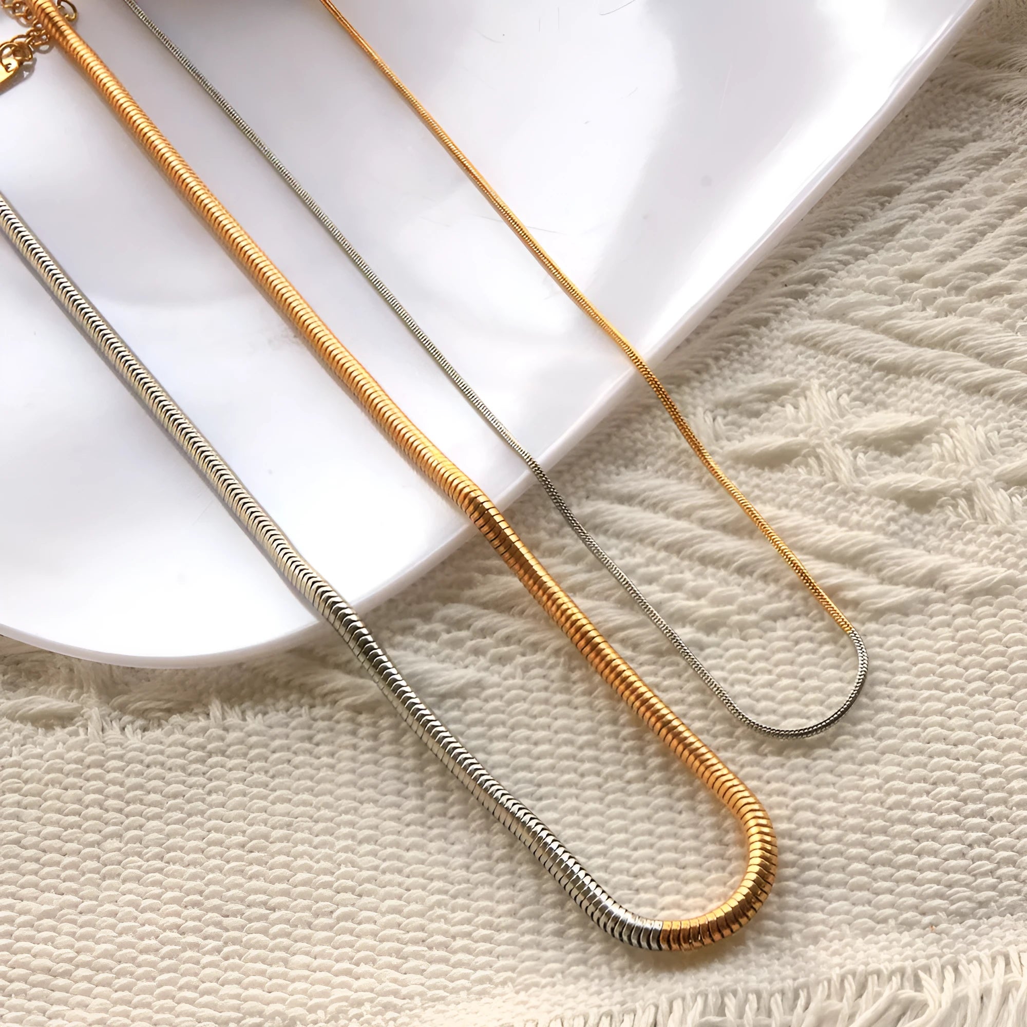 Gold-coloured stainless steel snake chain necklace for women, 3mm wide with geometric links.
