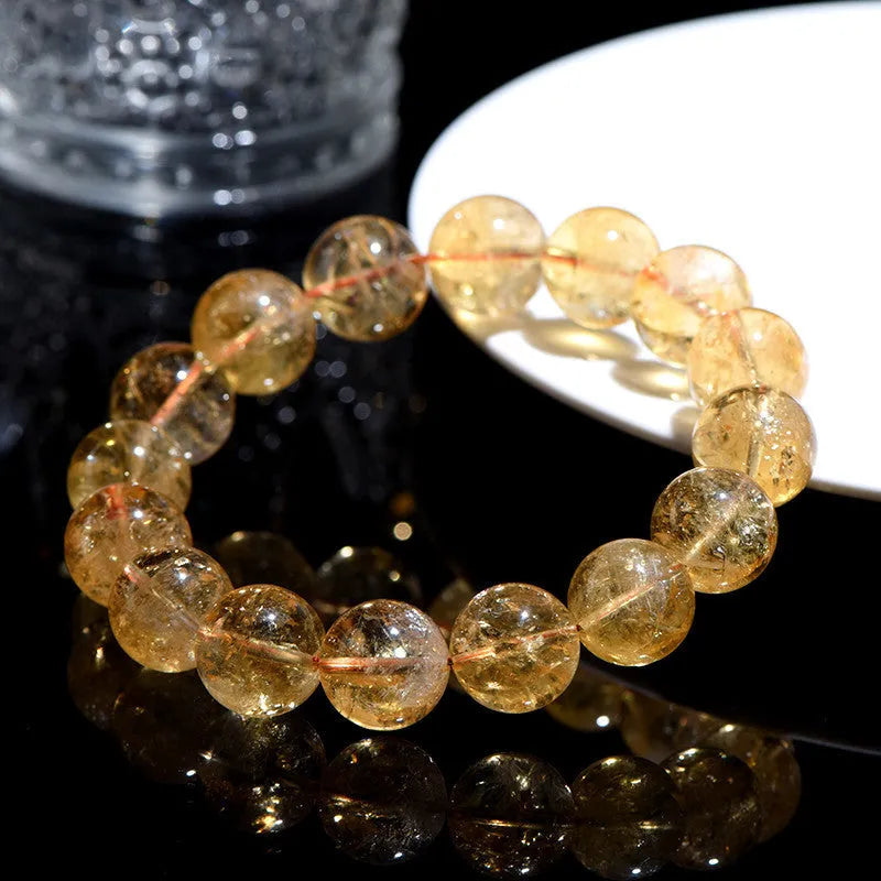 Natural yellow citrine gemstone bracelet showing single circle and three circle bead designs on a wrist.
