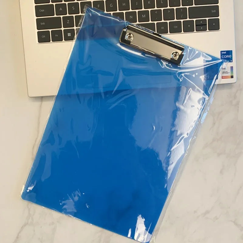 Transparent A4 plastic writing board pad with a silver metal clip, shown in blue colour.
