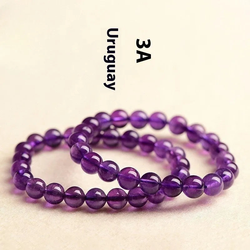 Natural amethyst Uruguay bracelet with scattered beads in various sizes on a wrist.
