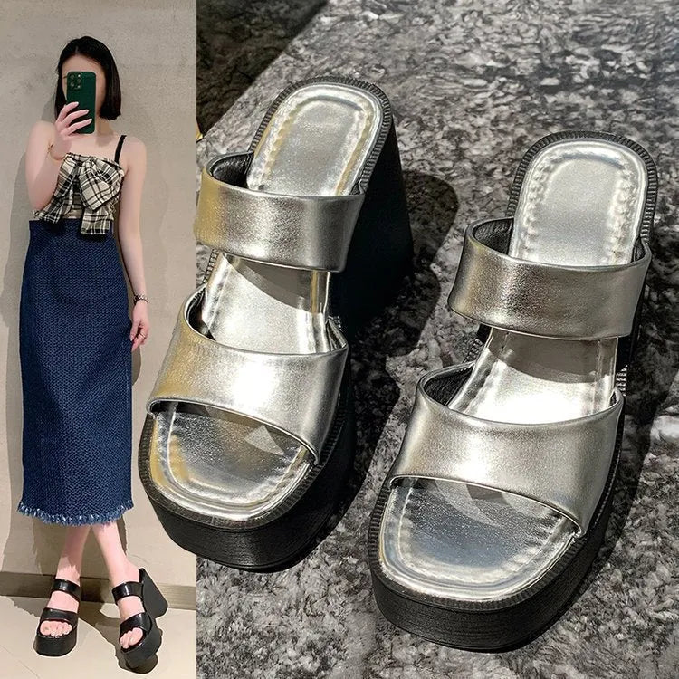 Women's black wedge platform slippers with square toe and PU upper.