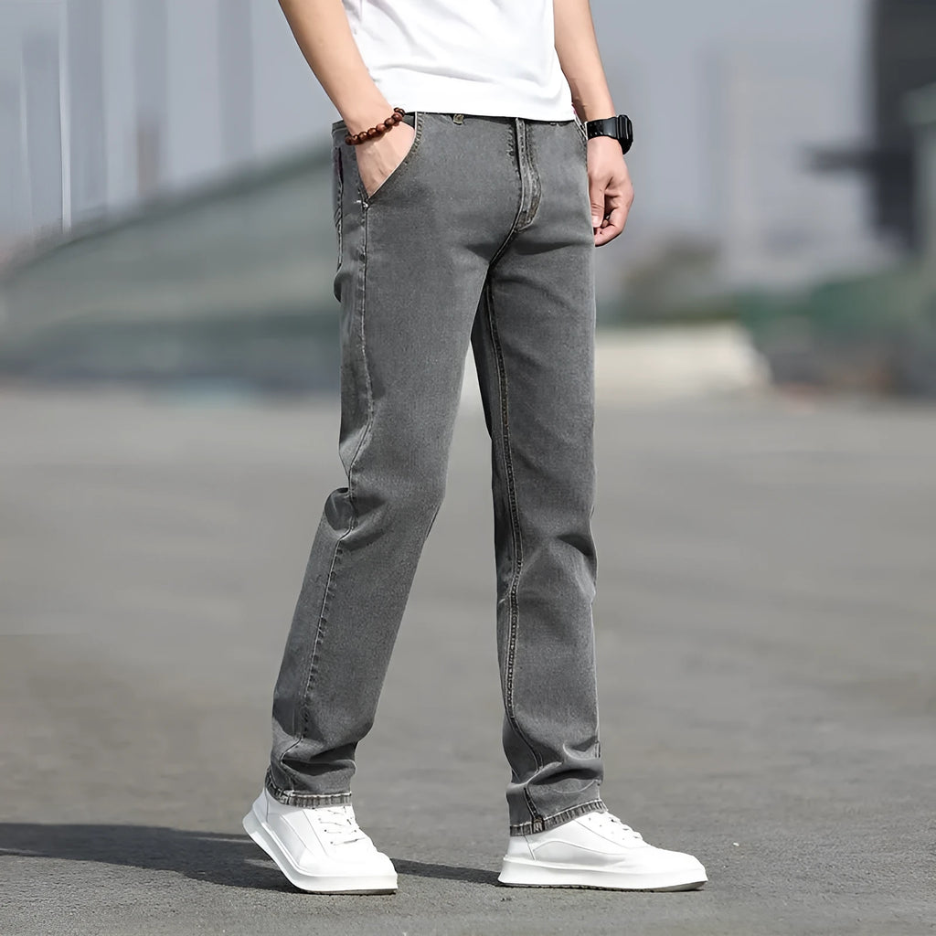 Men's smoky grey autumn jeans with straight tube fit and low waist design on hanger
